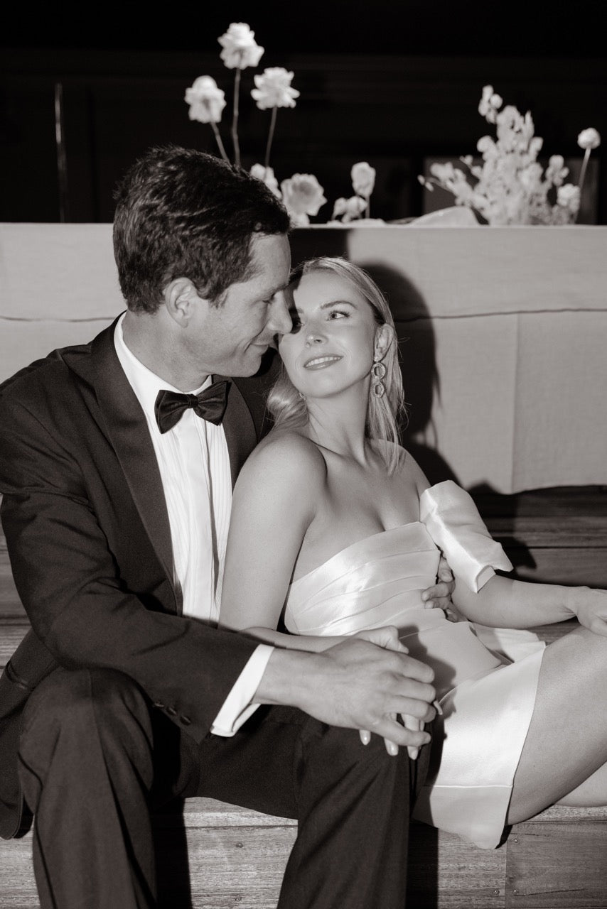 Bride wearing the TYLER Statement Wedding Earrings by Amélie George – gold and crystal bridal earrings designed to add sparkle and elegance to a modern wedding reception look.