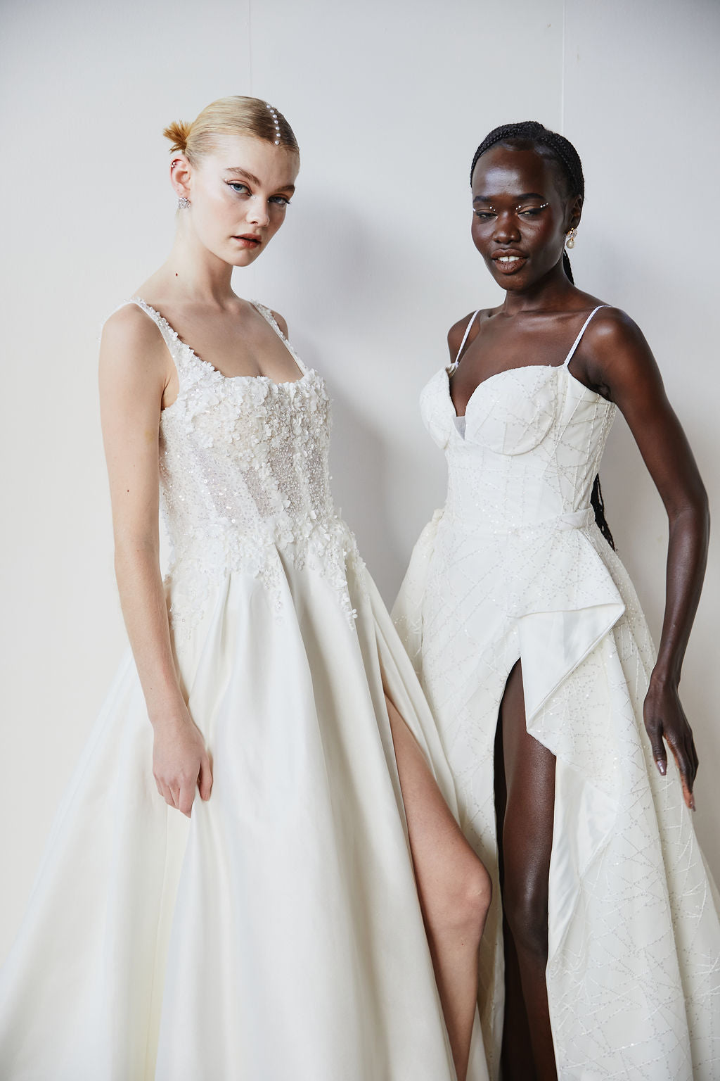 Model walking the One Fine Day Wedding Fair runway wearing minimalist silk wedding gown and pearl bridal earrings by Amélie George Bridal, styled with matching pearl wedding hair pins.