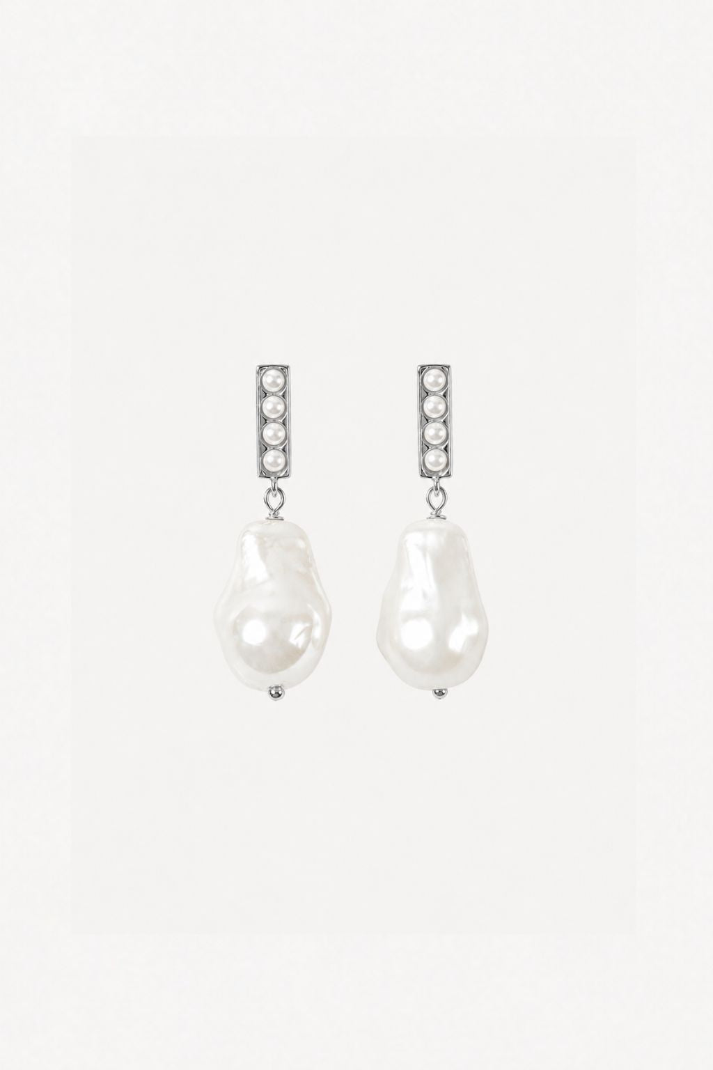 Pair of pearl earrings with clear gemstones on a white background