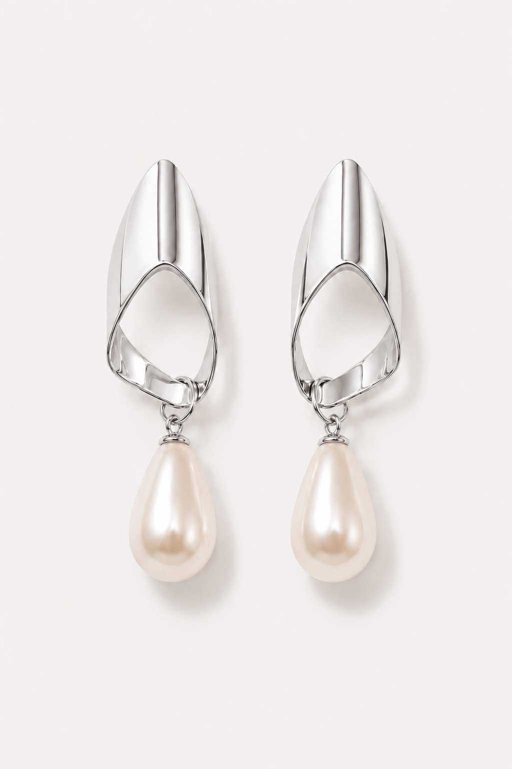 Silver earrings with pearl drops on a white background
