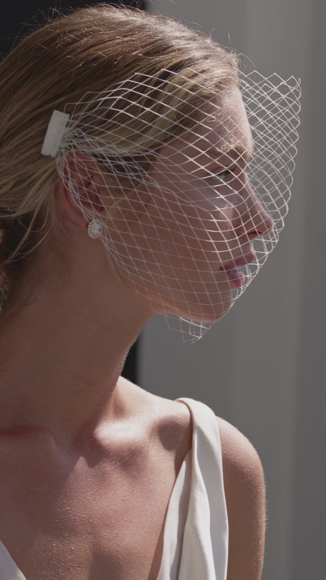 Video of net birdcage wedding veil on vintage inspired bride.