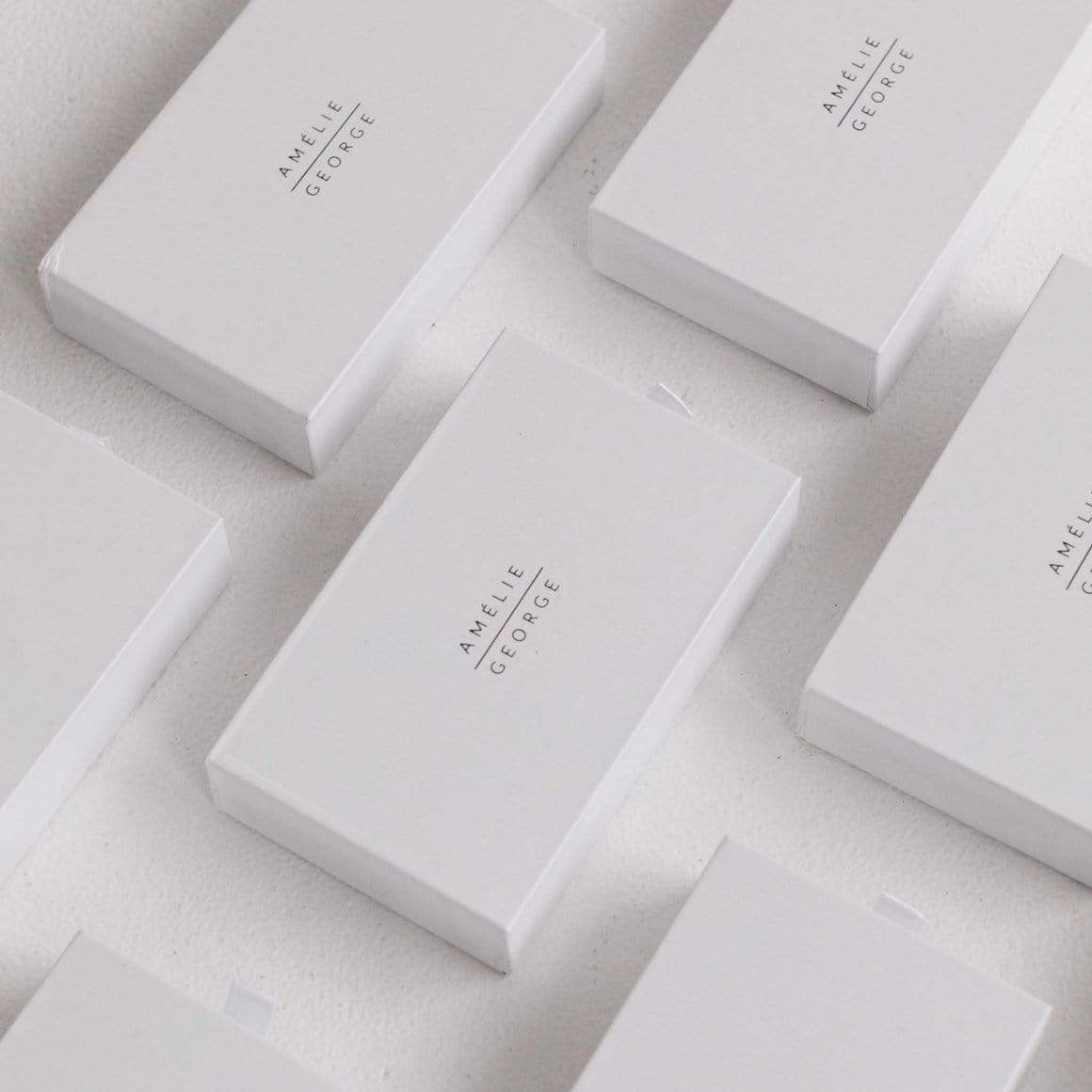 Amelie George Bridal White Gift Boxes are organized into a row.