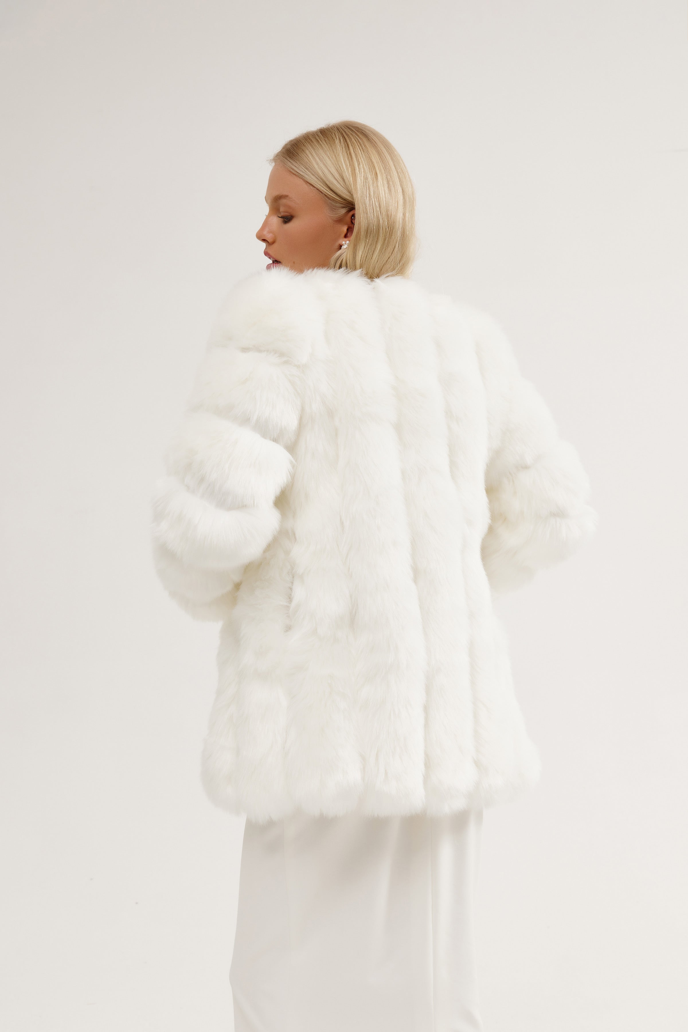Stunning bride wearing a long bolero jacket, combining elegance and warmth for a winter bridal look.