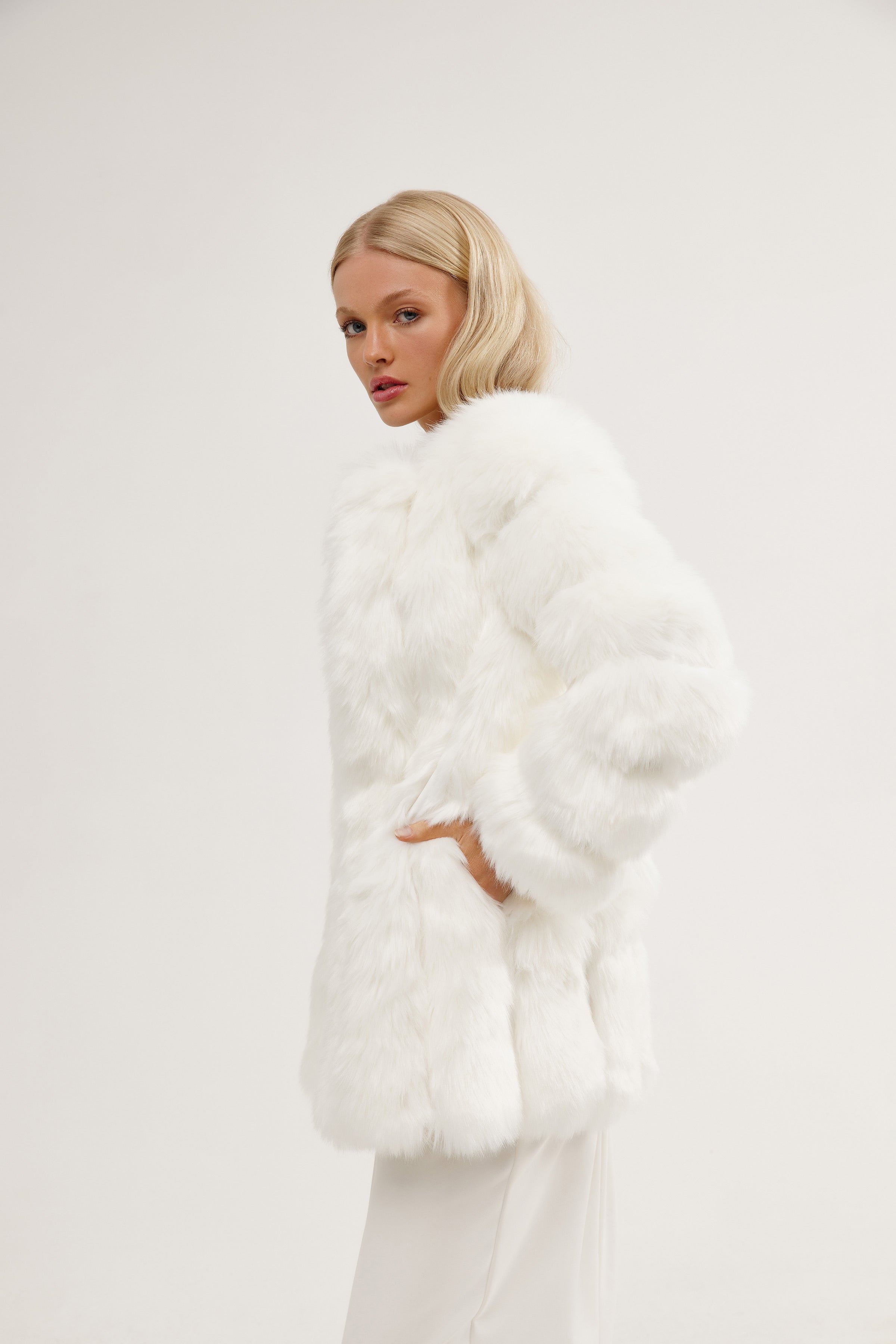 Model in a bridal fur jacket, offering warmth and sophistication for the modern bride on her wedding day.