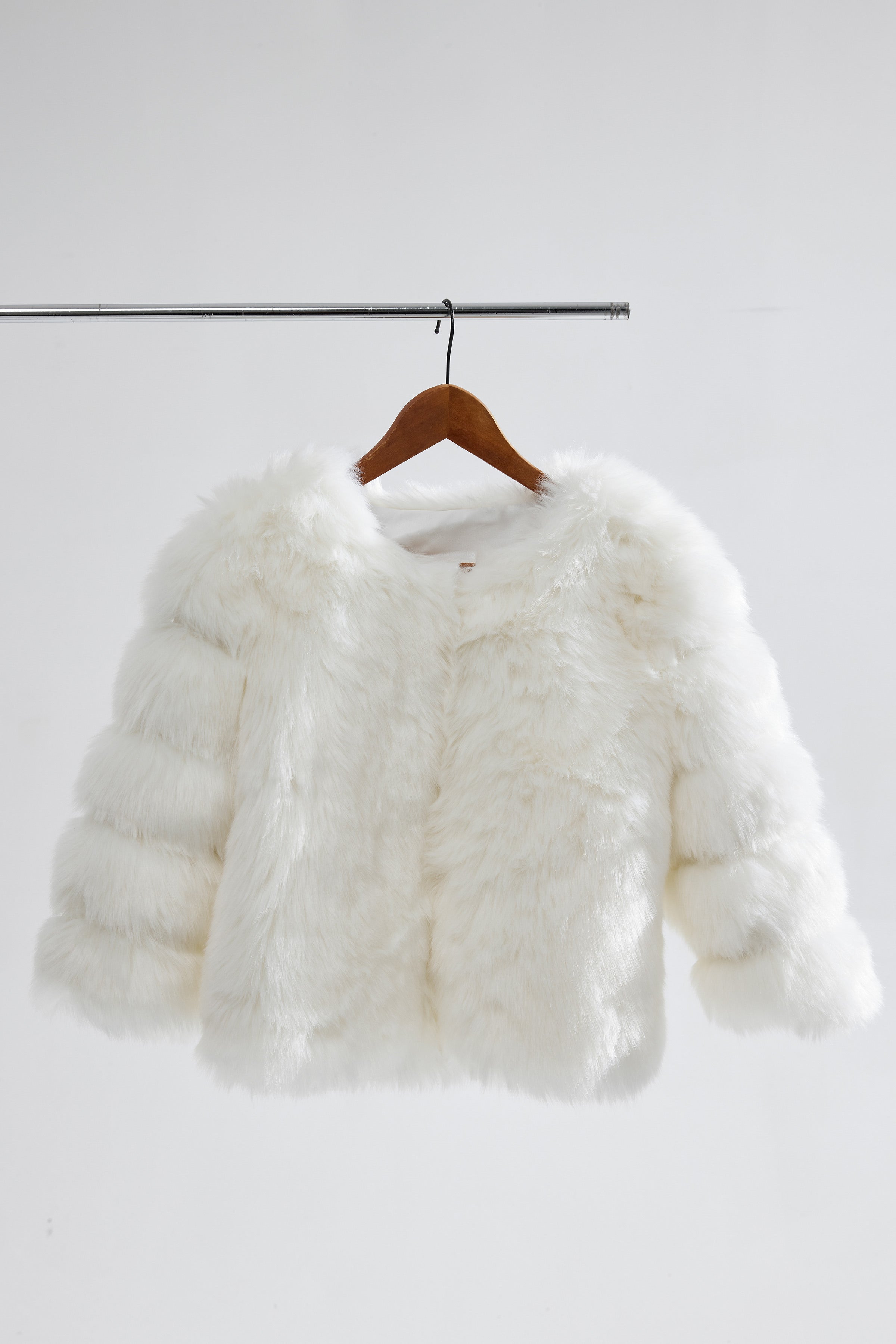 A cropped bridal jacket, adding a modern touch to a classic wedding gown.