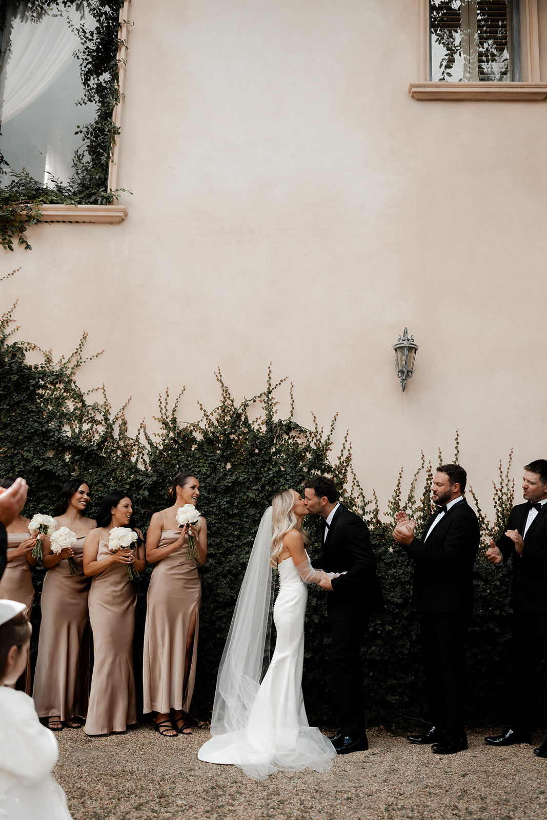 Bride Amy wearing a strapless crepe wedding gown with sheer tulle gloves, long single-tier veil, and HARPER crystal bridal earrings, captured at Villarica Estate by Love Wild Weddings.