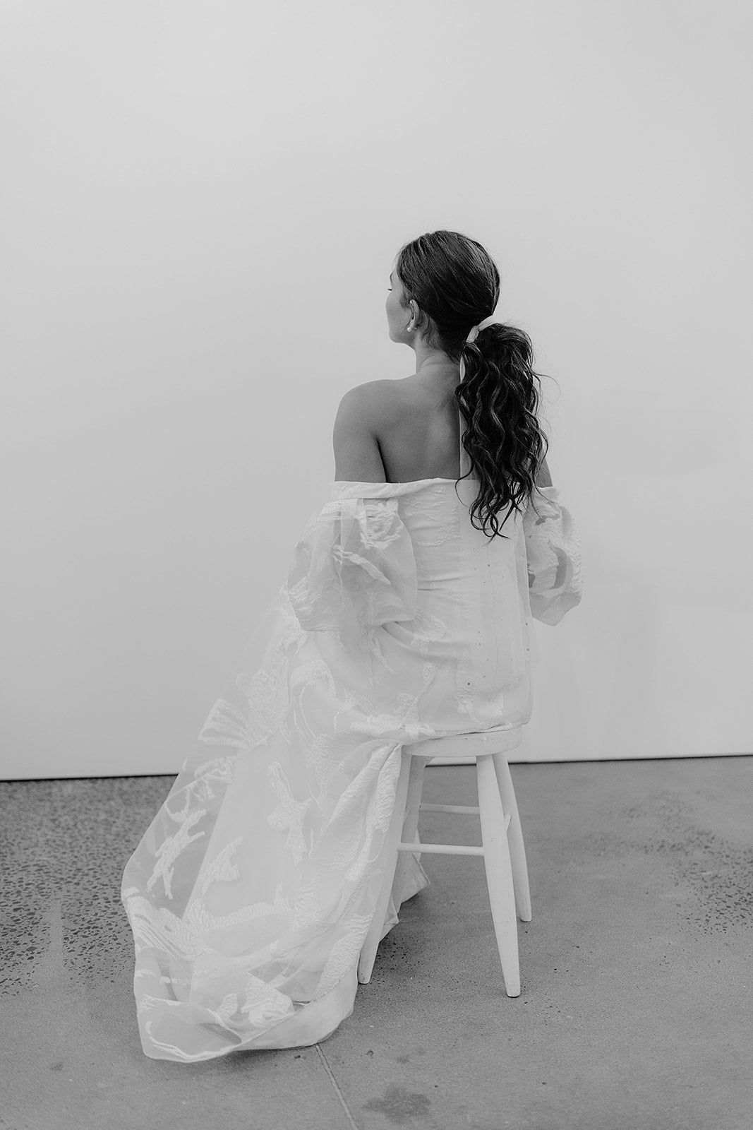 Elegant bride with a soft, ethereal bow veil tied in her hair, adding a delicate touch to her wedding day look.