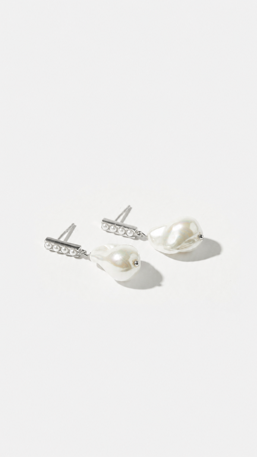 Pair of pearl wedding earrings on a white background