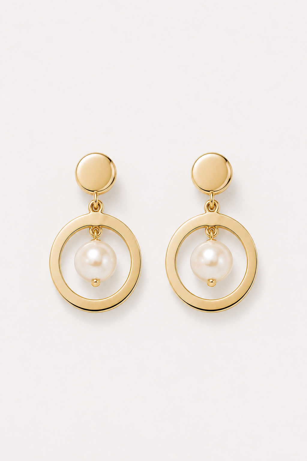 Gold earrings with pearl on a white background