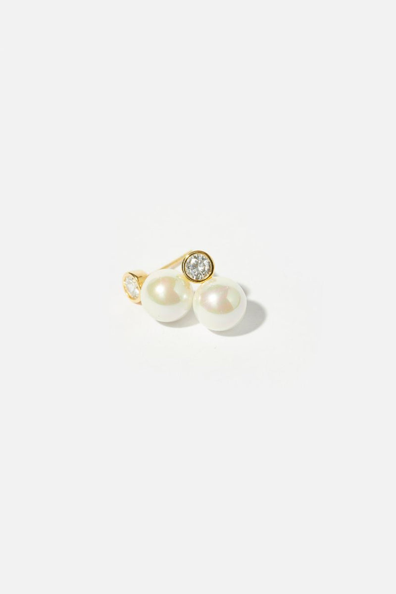 Minimalist Pearl Wedding Earrings with Gold Crystal Accent on a white table in the sun - Elegant Bridal Jewelry for Timeless Beauty and Grace