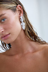 An image featuring a bride with timeless sparkle, wearing elegant crystal bridal earrings