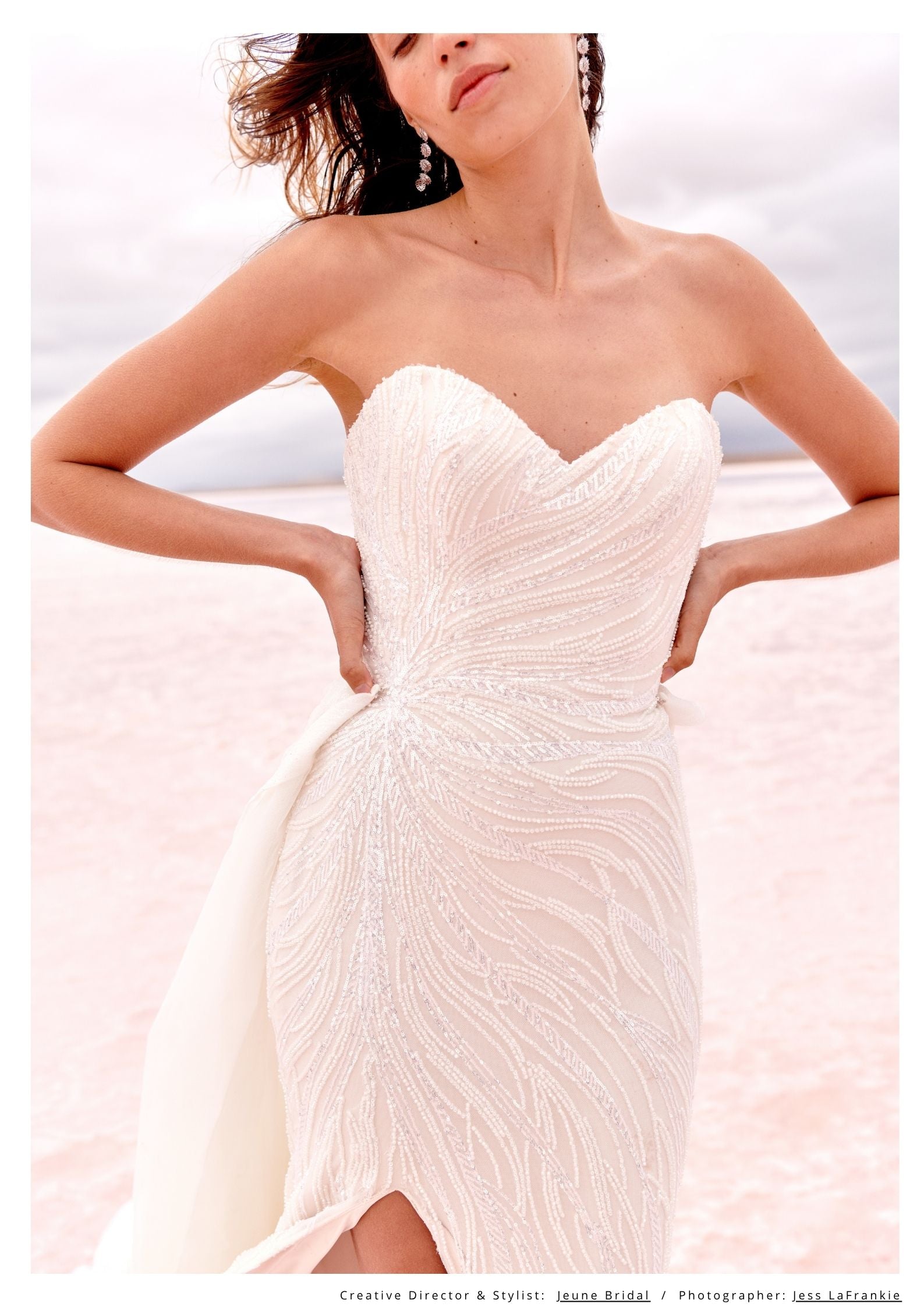 Woman wearing a strapless white dress with a textured bodice against a light background