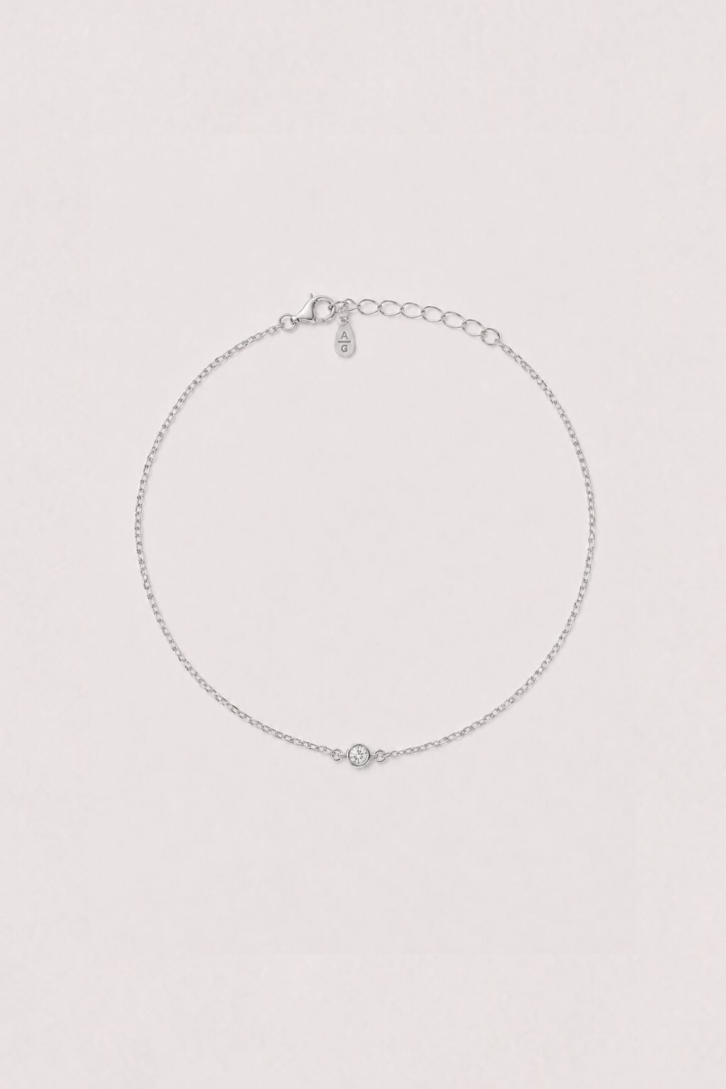 Silver anklet on a light gray background