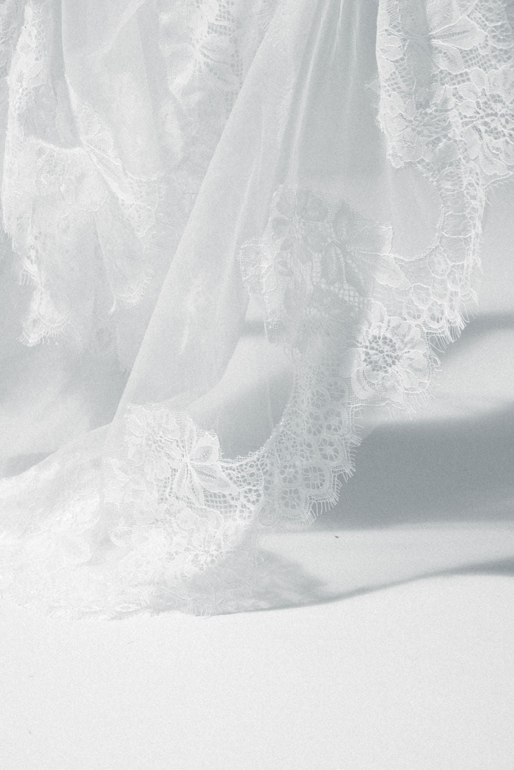 Elegant bride in a handcrafted lace bridal veil, featuring a soft and lightweight lace edge veil with blusher.