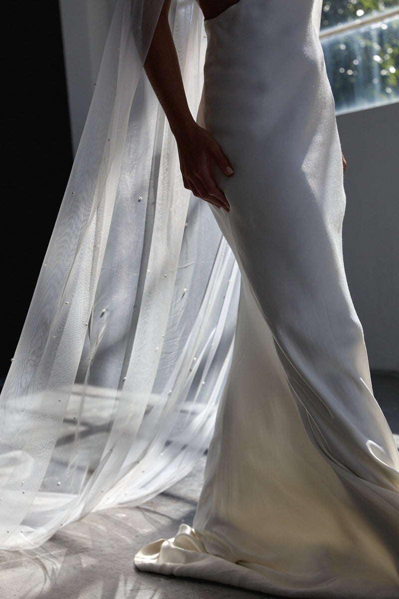 long cathedral pearl wedding veil. Image showing the veil draping out longer than the bridal train.