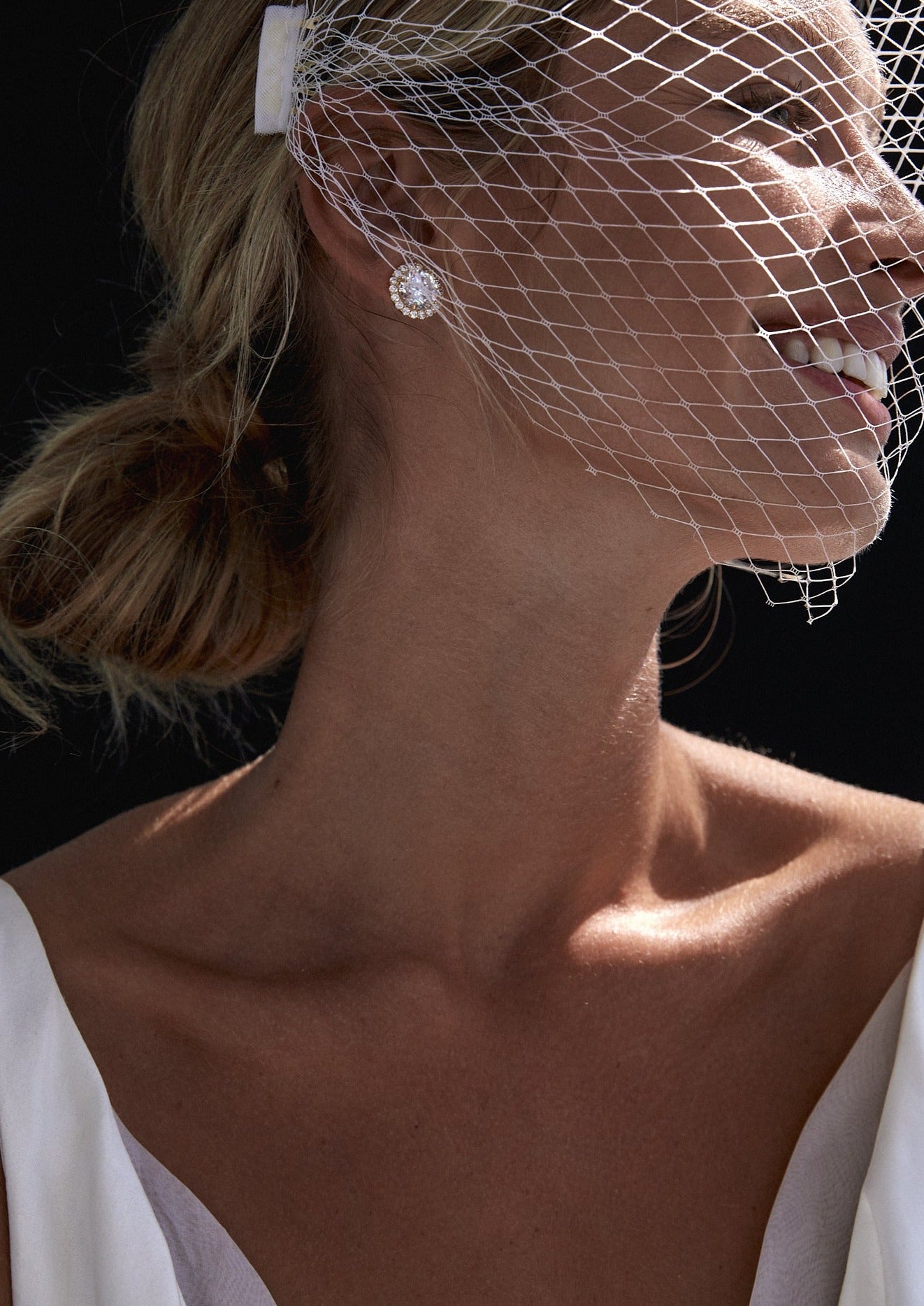 Elegant bride showcasing a French net birdcage veil as the perfect bridal accessory for a timeless and sophisticated wedding look.