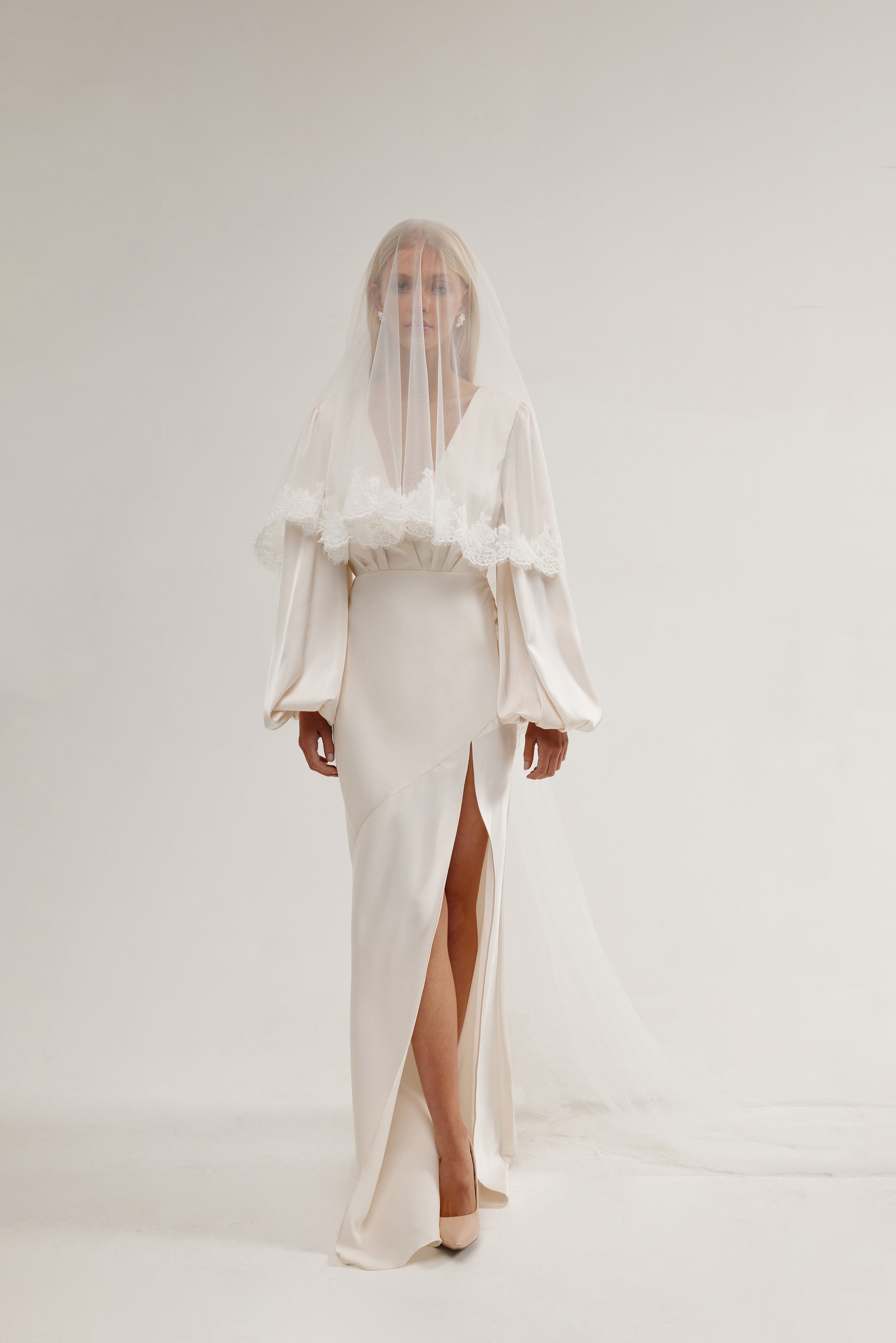 Bride in a bridal lace veil with two tiers, offering a romantic and timeless look with a delicate lace edge veil.