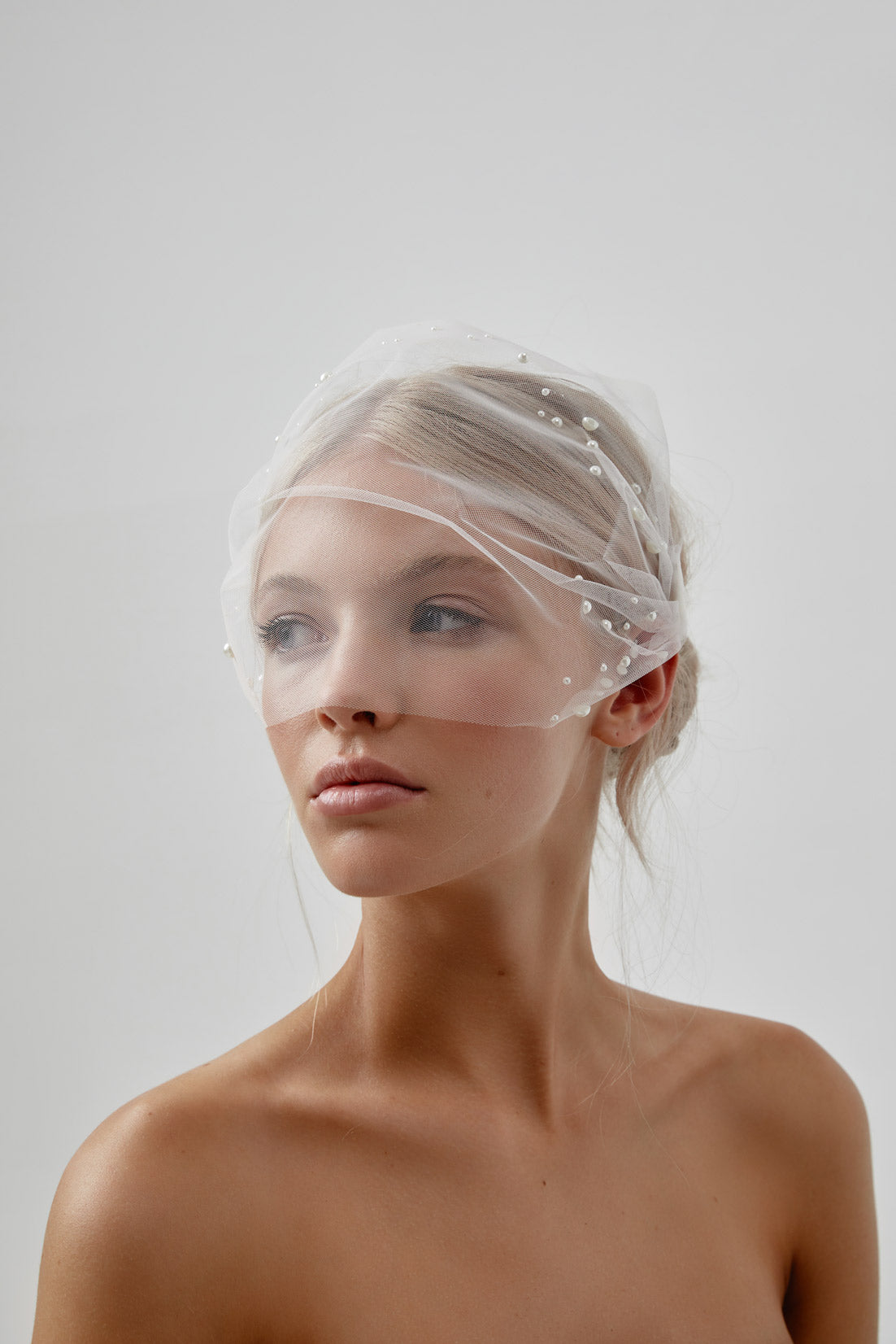 Beautiful bride showcasing a Pearl Birdcage Veil, combining classic vintage charm with modern bridal elegance.