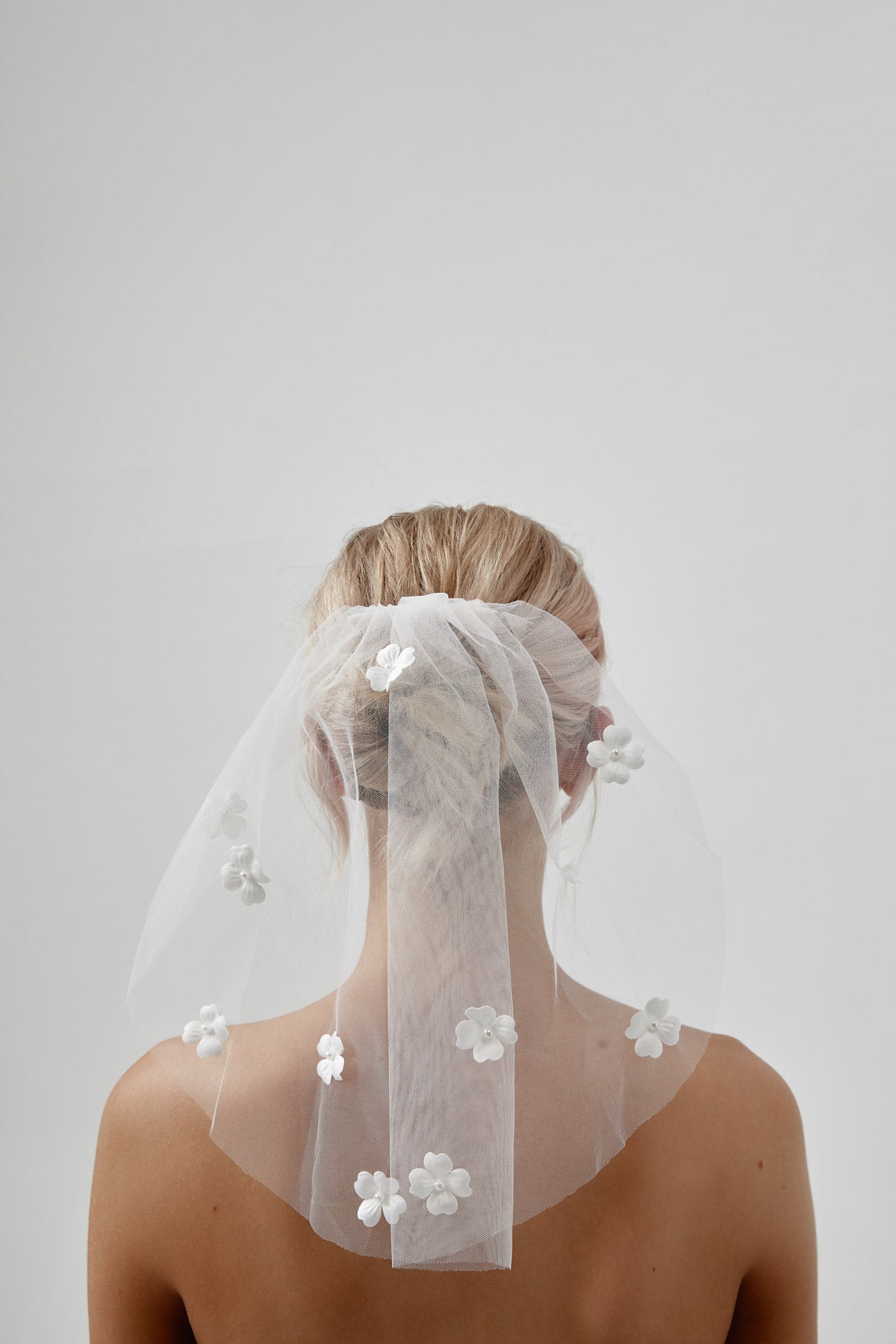 Bride and veil with delicate floral accents, featuring a stunning dress veil for her special day in Australia.
