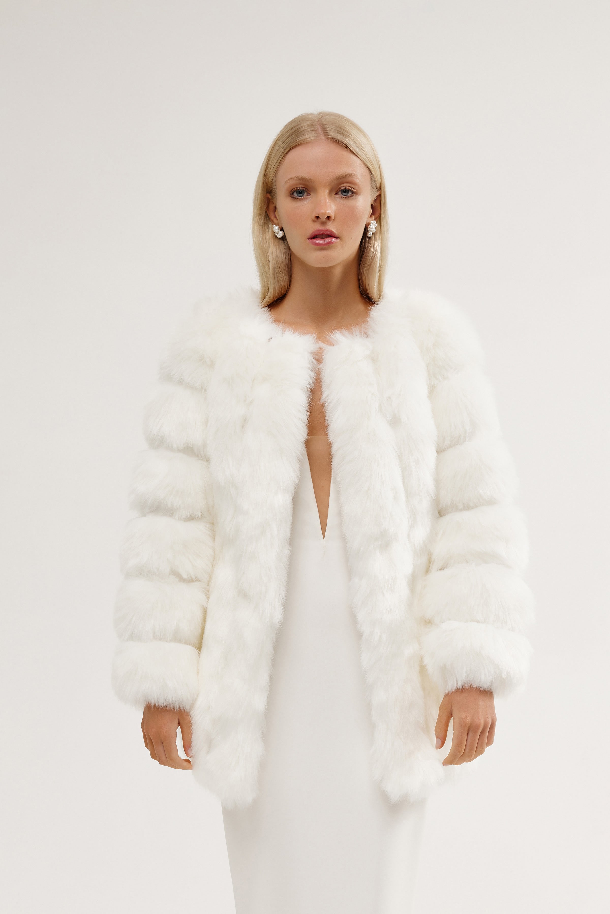 Bride showcasing a winter bridal fur coat, a timeless piece perfect for winter brides seeking a luxurious wedding fur jacket.