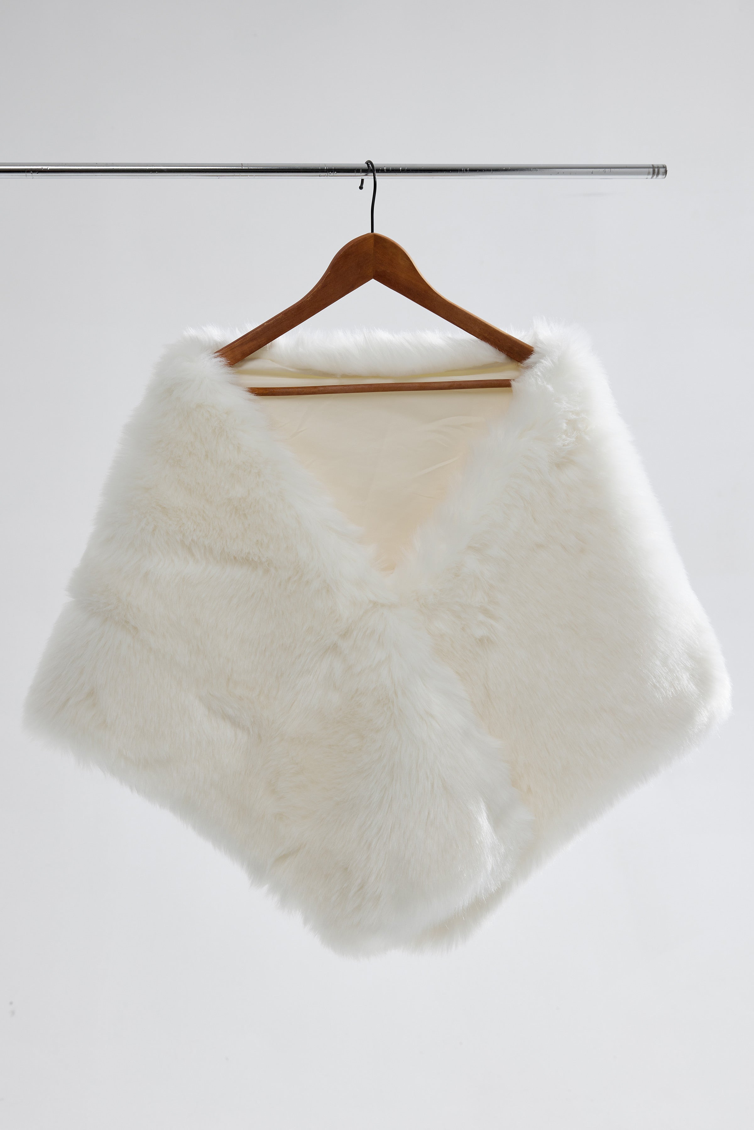 Flatlay of a large vegan fur wedding shawl, showcasing the soft faux fur and tiered design