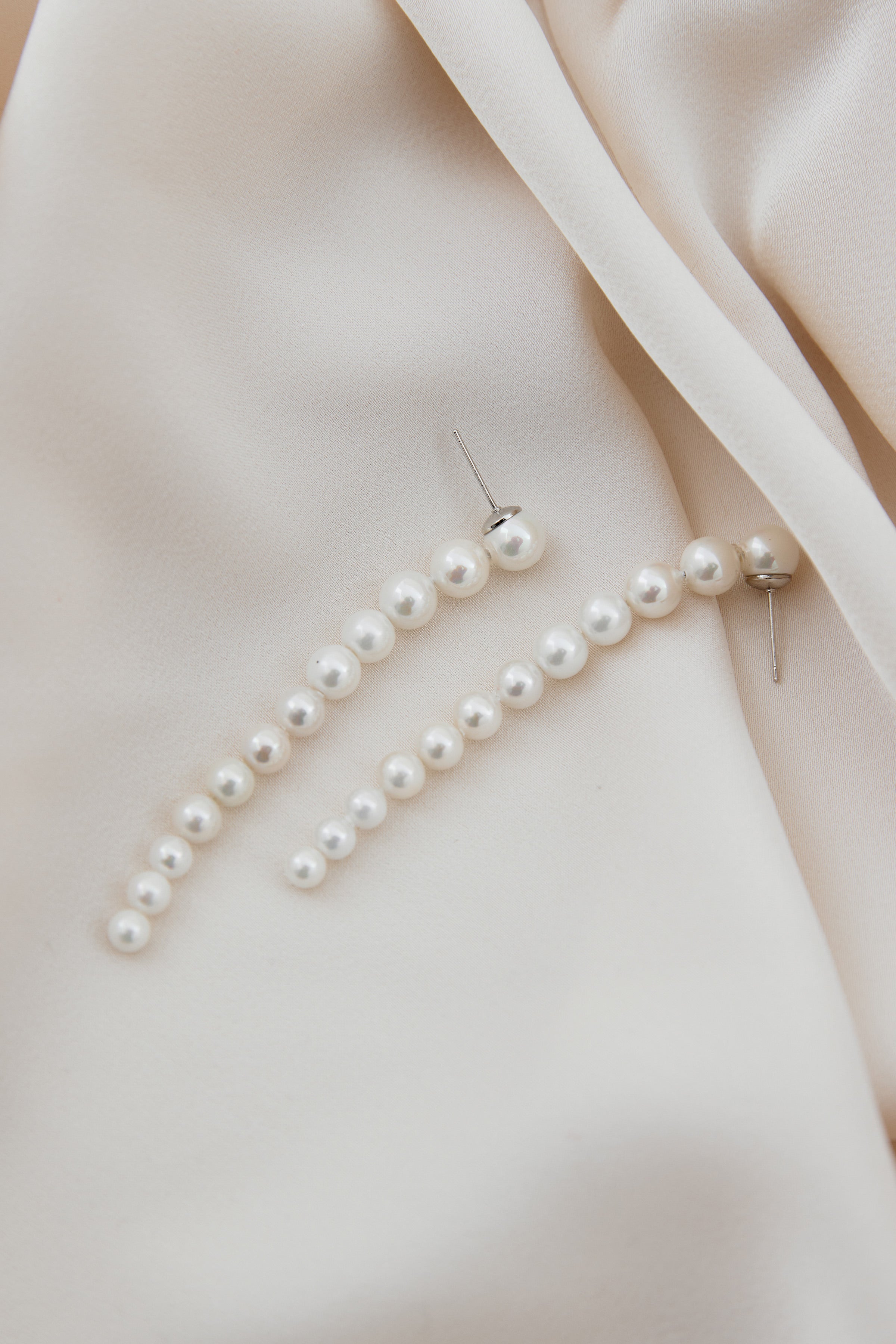 OLYMPIA silver pearl drop earrings, minimalist bridal earrings featuring delicate silver details and soft, elongated pearls for an elegant wedding look.