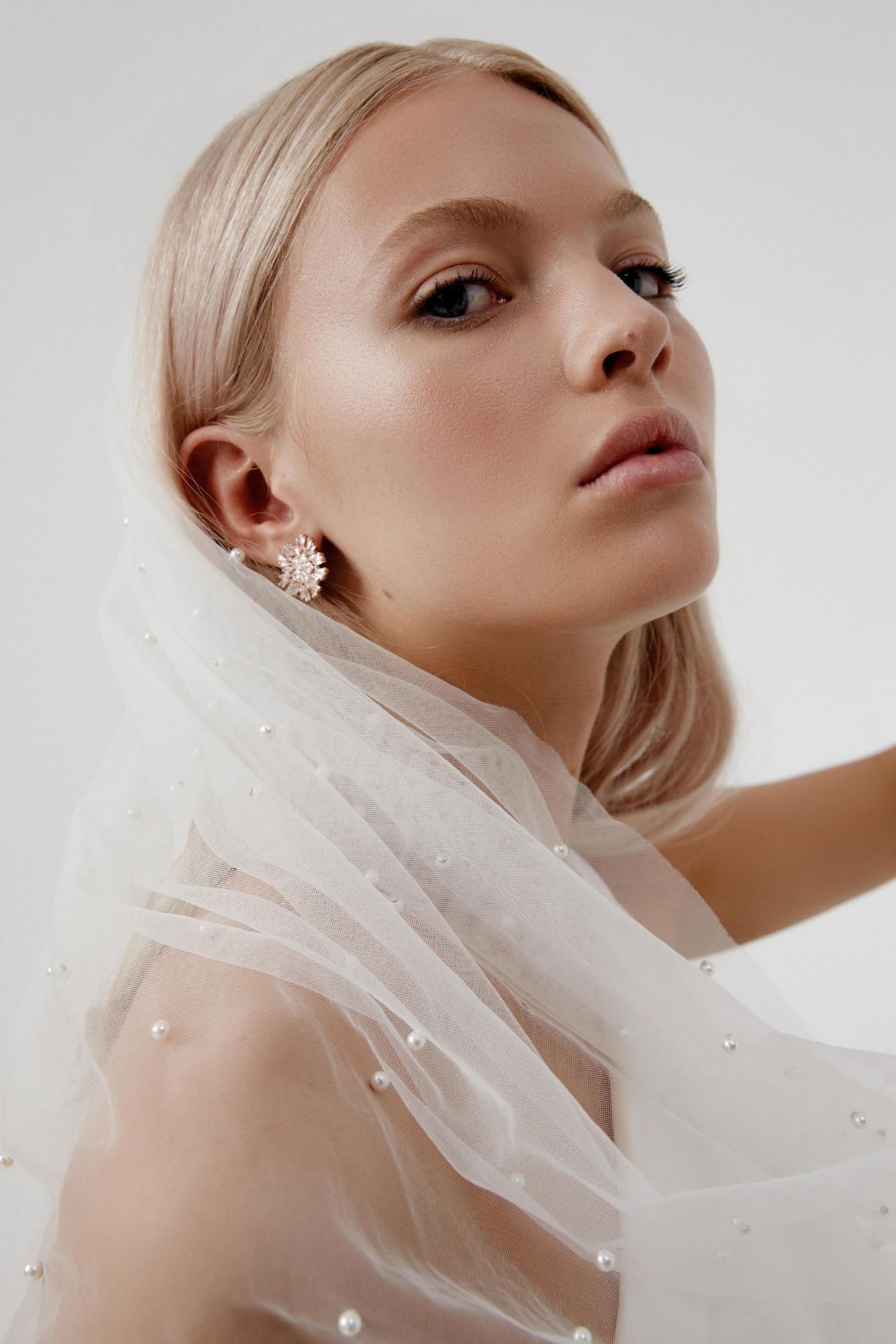Bride wearing a pearl wedding veil in ivory tulle – front view of bridal veil with pearls