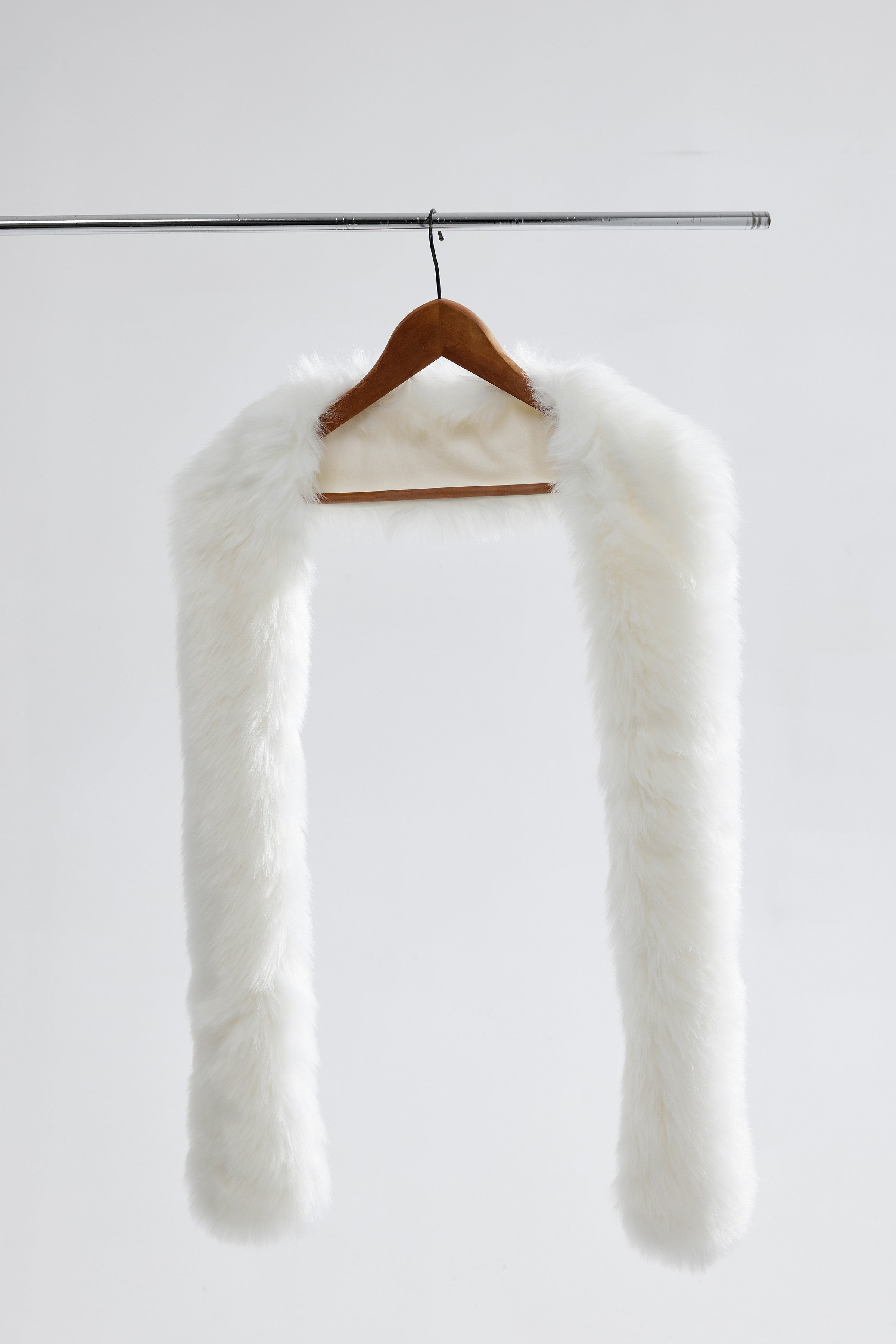 Flatlay of a small vegan fur wedding shawl, highlighting its soft faux fur and delicate texture